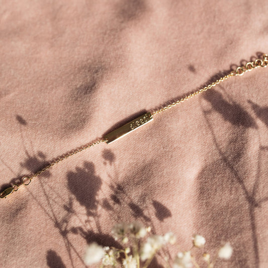 Personalised kids gold bracelet featuring custom engraved name plate, handcrafted by Leesha Fine Jewellery