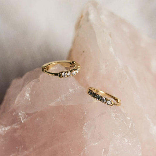 Mini Diamond Huggies 12mm displayed on a white background, showcasing seven round diamonds set in 9ct gold.