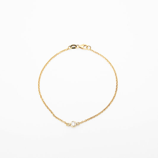 Minimalist gold bracelet featuring a single solitaire diamond, handcrafted by Leesha Fine Jewellery
