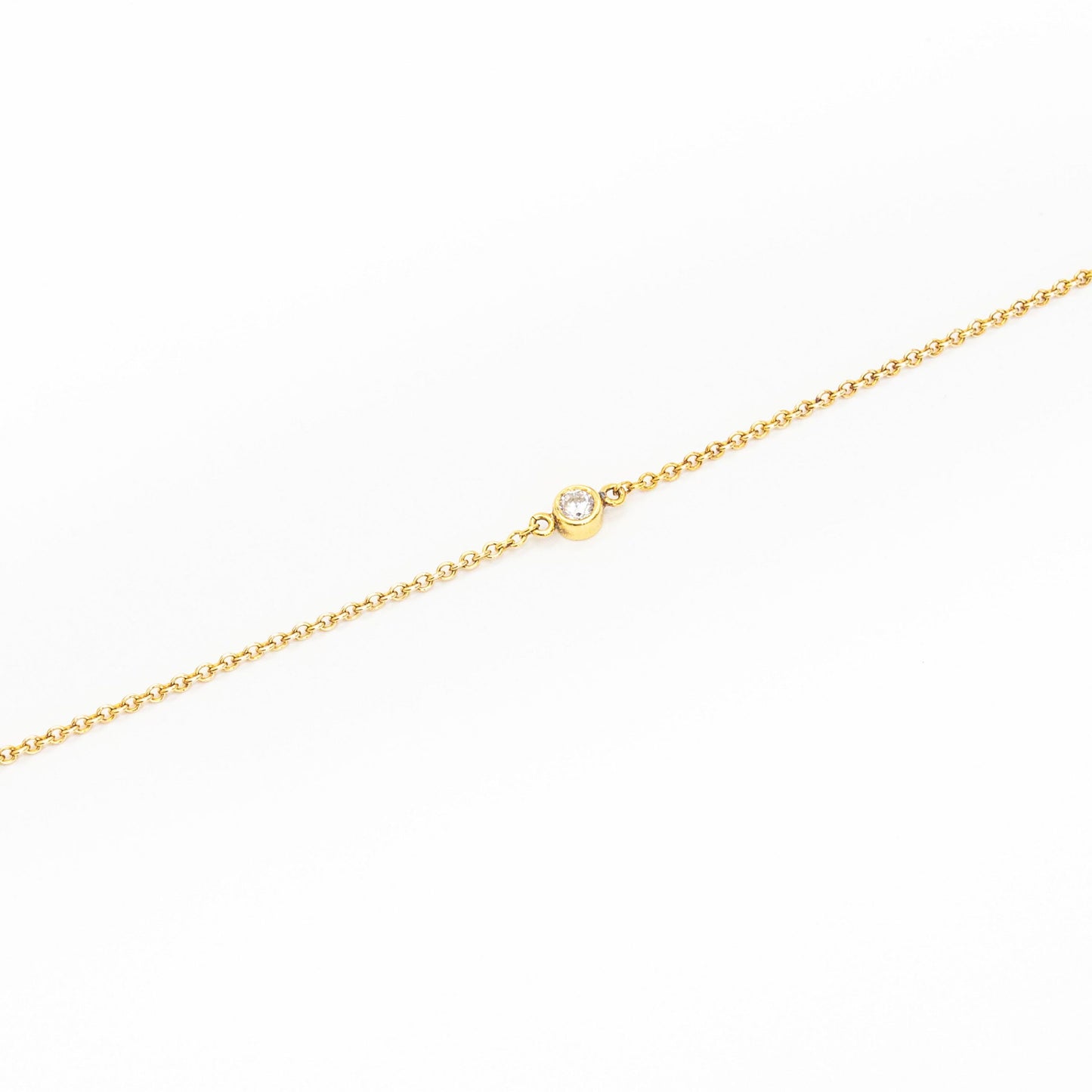 Minimalist gold bracelet featuring a single solitaire diamond, handcrafted by Leesha Fine Jewellery