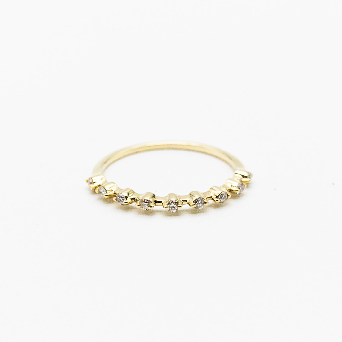 Spotted stacker ring with nine white diamonds on a thin 9ct gold band