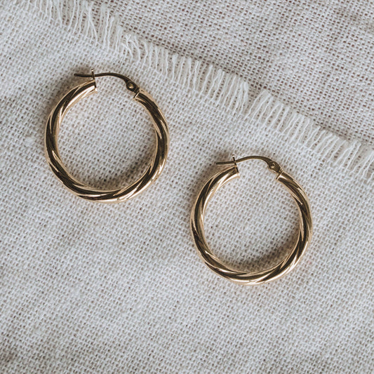 Textured 9ct gold hoop earrings featuring a 2mm twisted tube design.