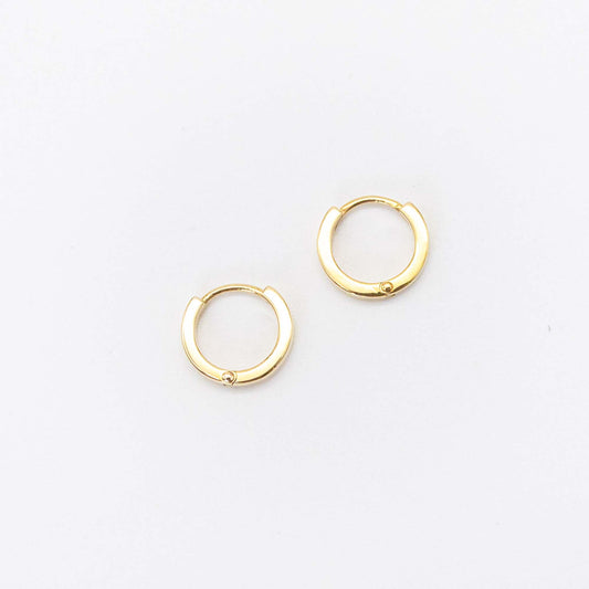 Front view of a pair of simple polished gold mini huggie hoop earrings.
