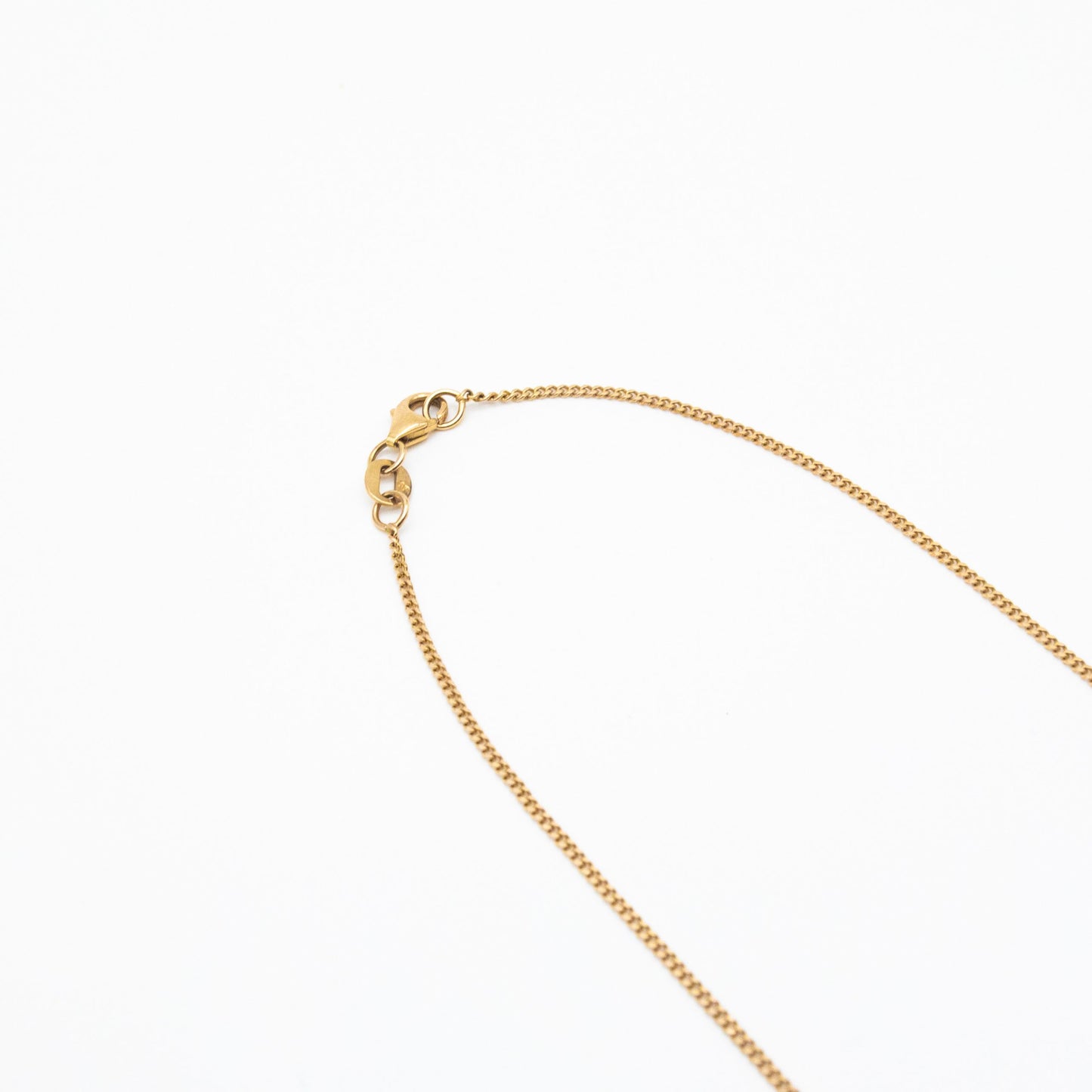 1.2mm curb link chain in 9ct yellow gold flatlay with white background