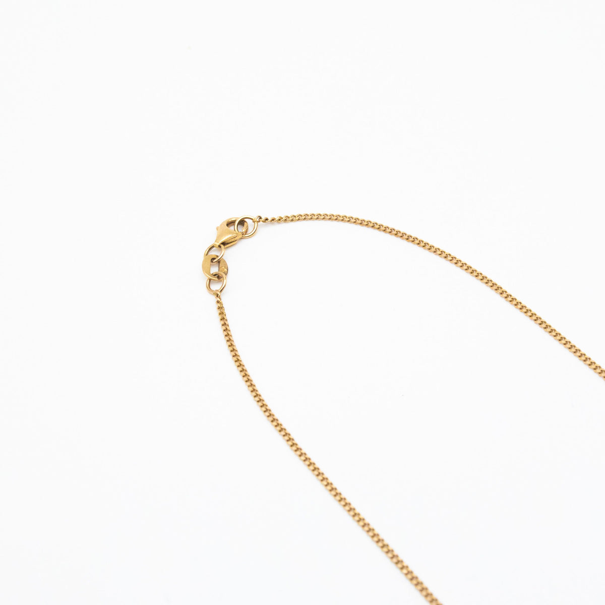 1.2mm curb link chain in 9ct yellow gold flatlay with white background