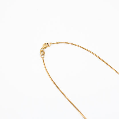 1.2mm curb link chain in 9ct yellow gold flatlay with white background