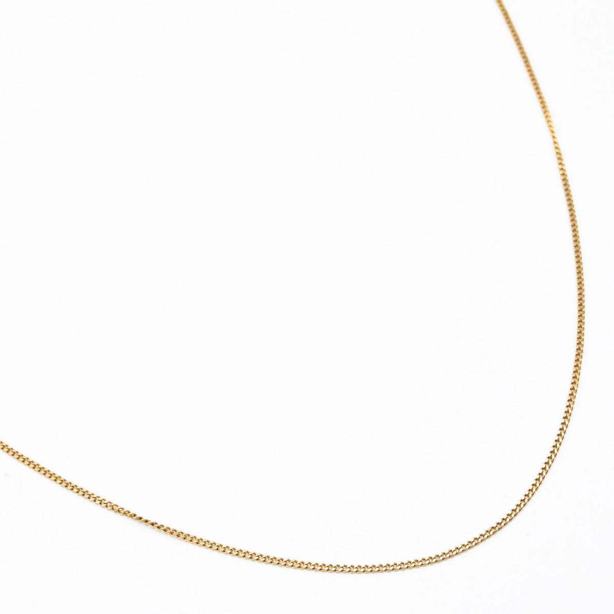 1.2mm curb link chain in 9ct yellow gold flatlay with white background
