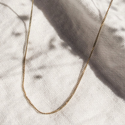 1.2mm curb link chain in 9ct yellow gold flatlay