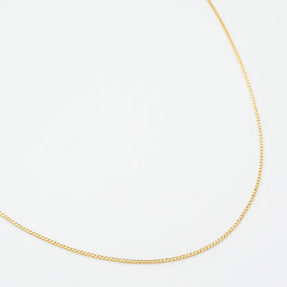 1.1mm Franco chain necklace in 9ct yellow gold laid flat on a white background.