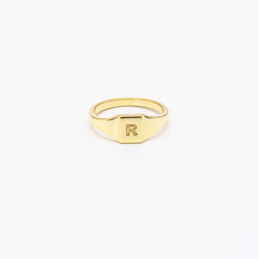 9ct solid gold pinky signet ring featuring a clean, modern face with an engraved initial, shown in yellow gold.