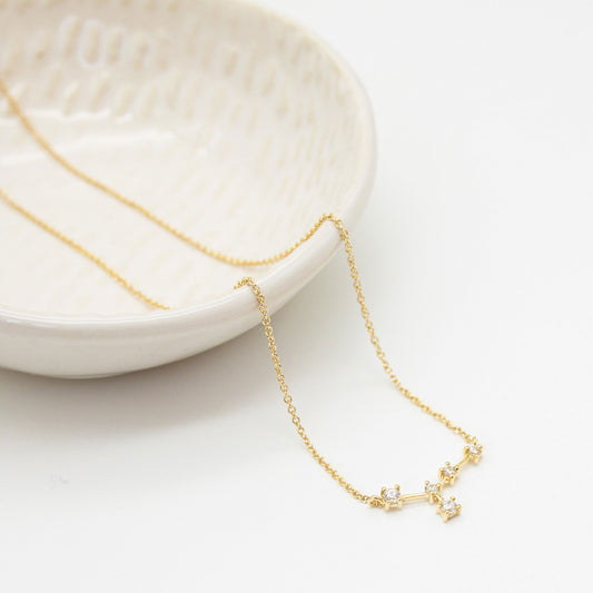 Personalised zodiac diamond necklace in 9ct yellow gold, featuring a cluster of sparkling diamonds representing your star sign.