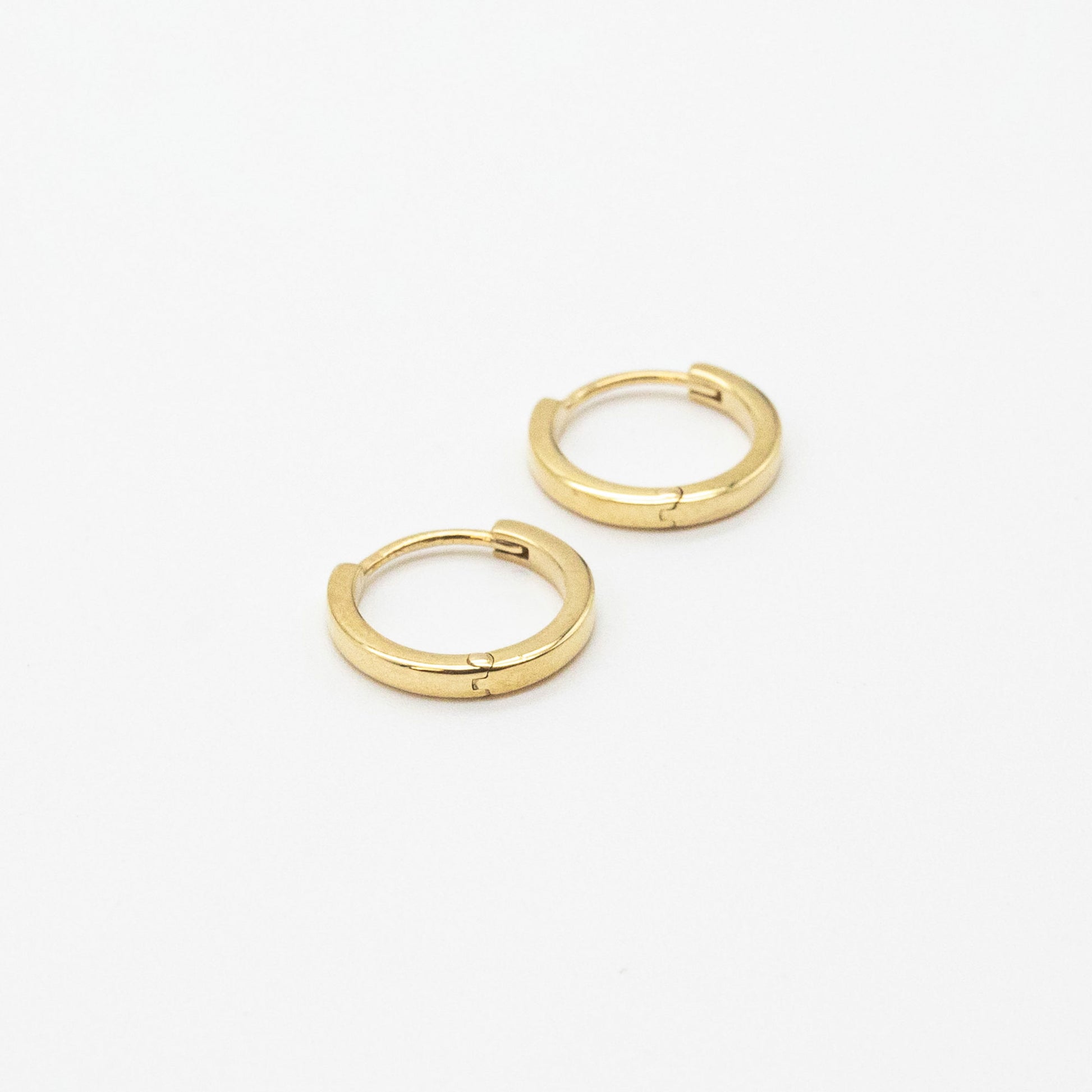 Bold mini gold hoop earrings from Leesha Fine Jewellery on a white background.