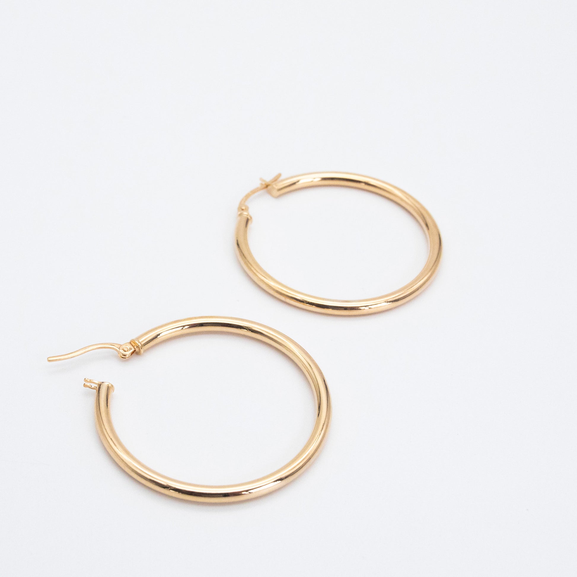 Classic Hoops shown side by side highlighting their polished gold finish
