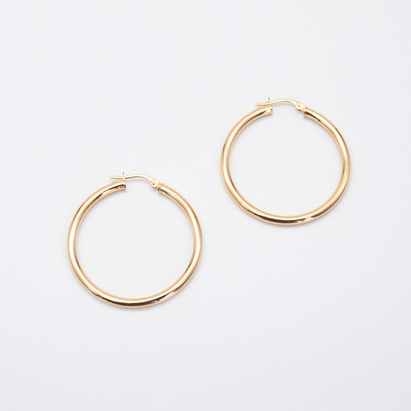 Classic Hoops shown side by side highlighting their polished gold finish