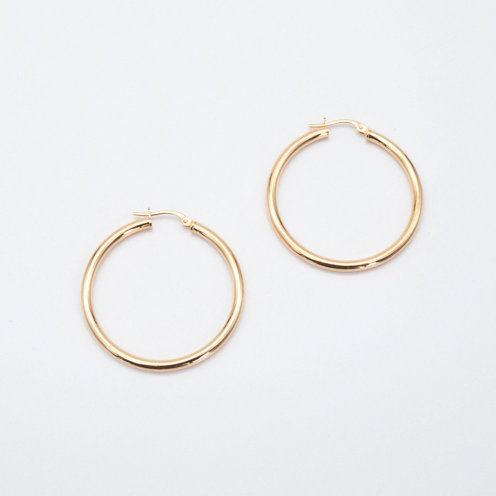 Classic Hoops shown side by side highlighting their polished gold finish