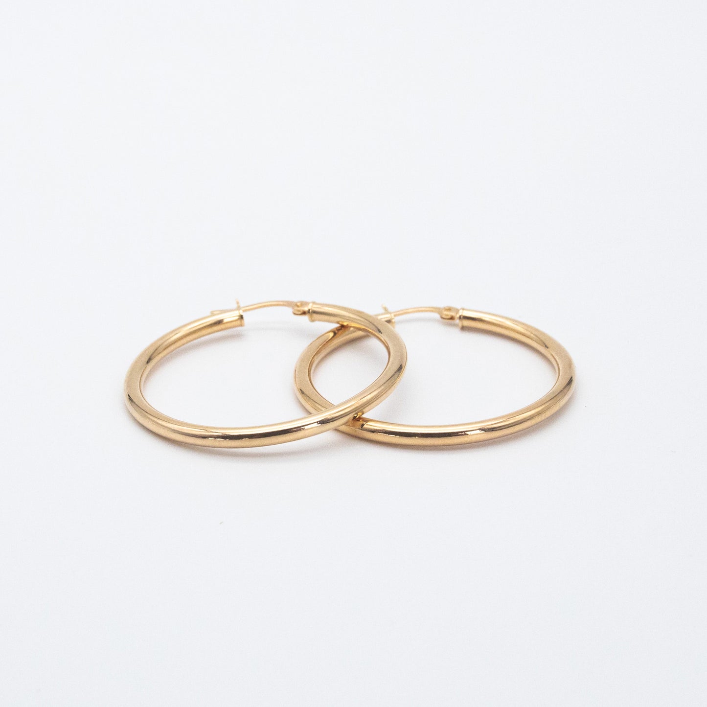 Classic Hoops shown side by side highlighting their polished gold finish