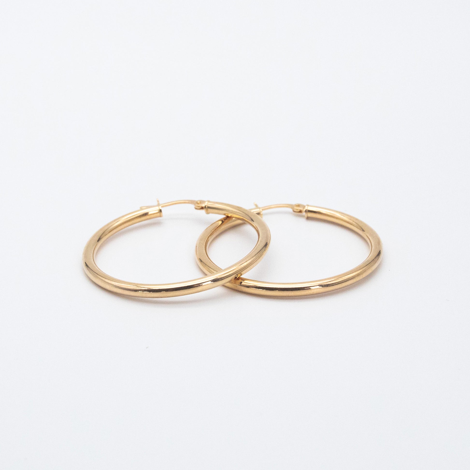 Classic Hoops shown side by side highlighting their polished gold finish