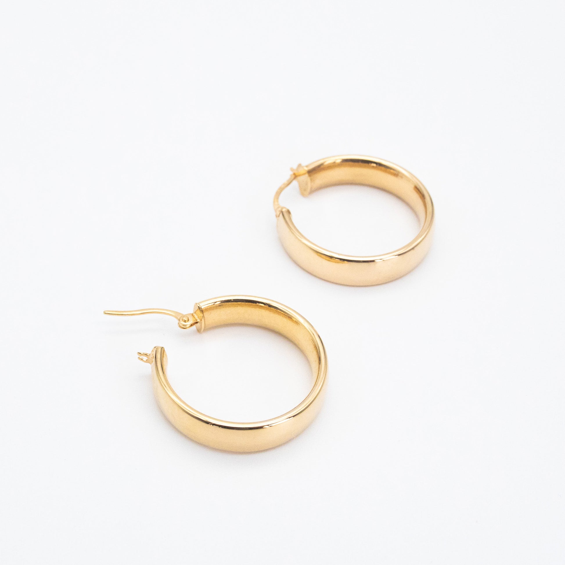 Small 9ct gold D-shape hoops displayed together on white background