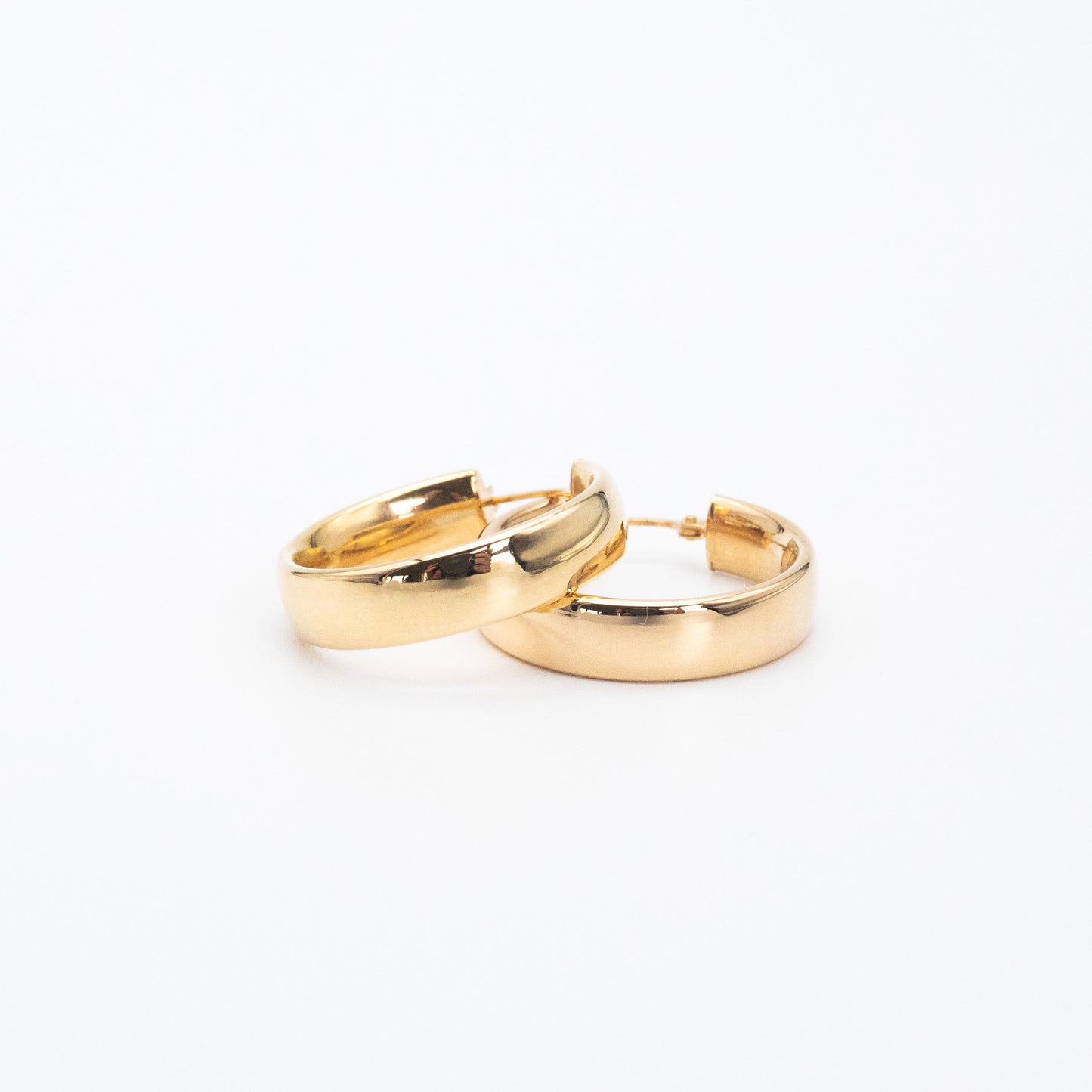 Small 9ct gold D-shape hoops displayed together on white background