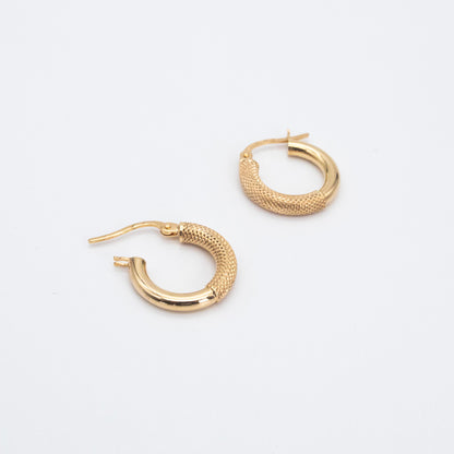 Pair of fancy gold hoops shown flat on a white backdrop