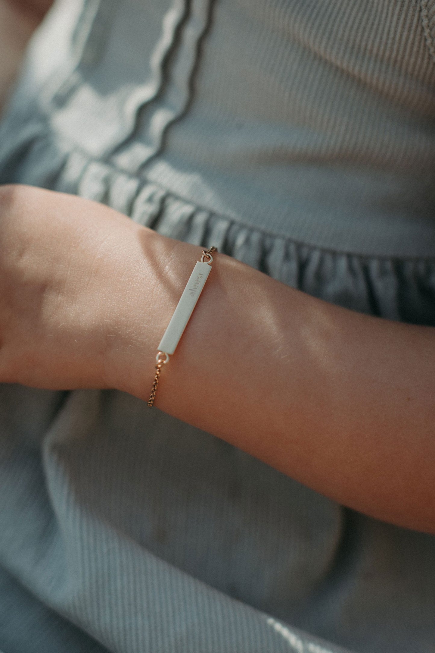 Personalised kids gold bracelet featuring custom engraved name plate, handcrafted by Leesha Fine Jewellery
