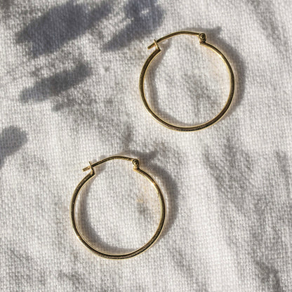 Side-by-side view of medium 9ct gold hoop earrings