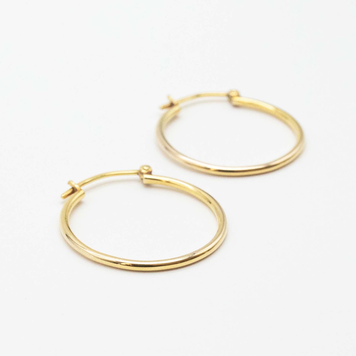 Side-by-side view of medium 9ct gold hoop earrings
