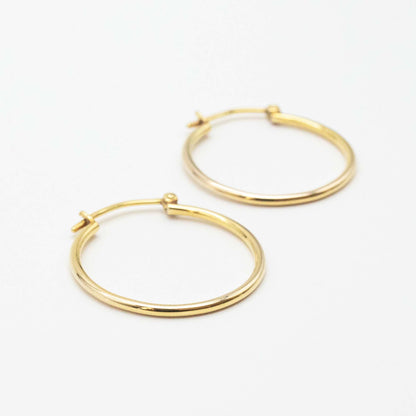 Side-by-side view of medium 9ct gold hoop earrings