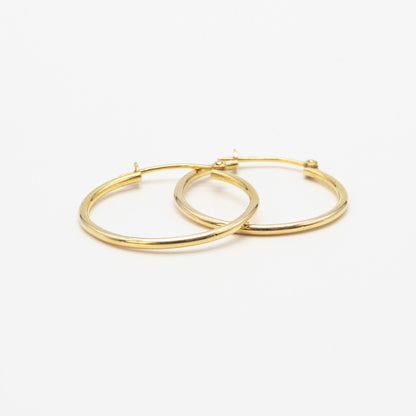 Side-by-side view of medium 9ct gold hoop earrings