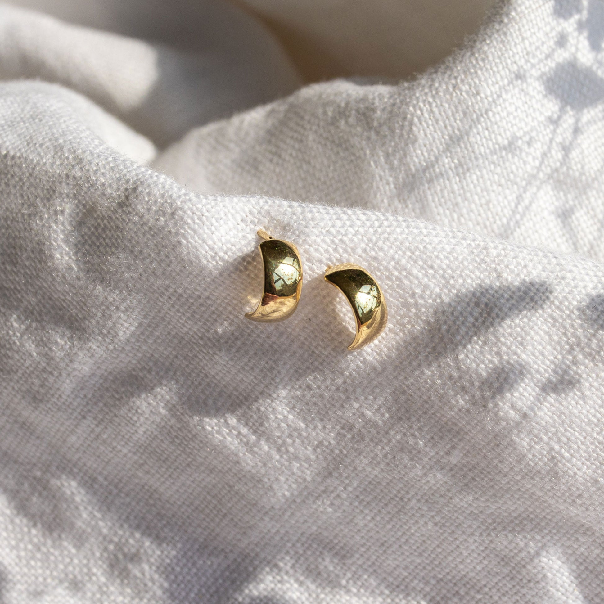 Single 9ct gold mini bold hoop earring showing smooth polished finish.