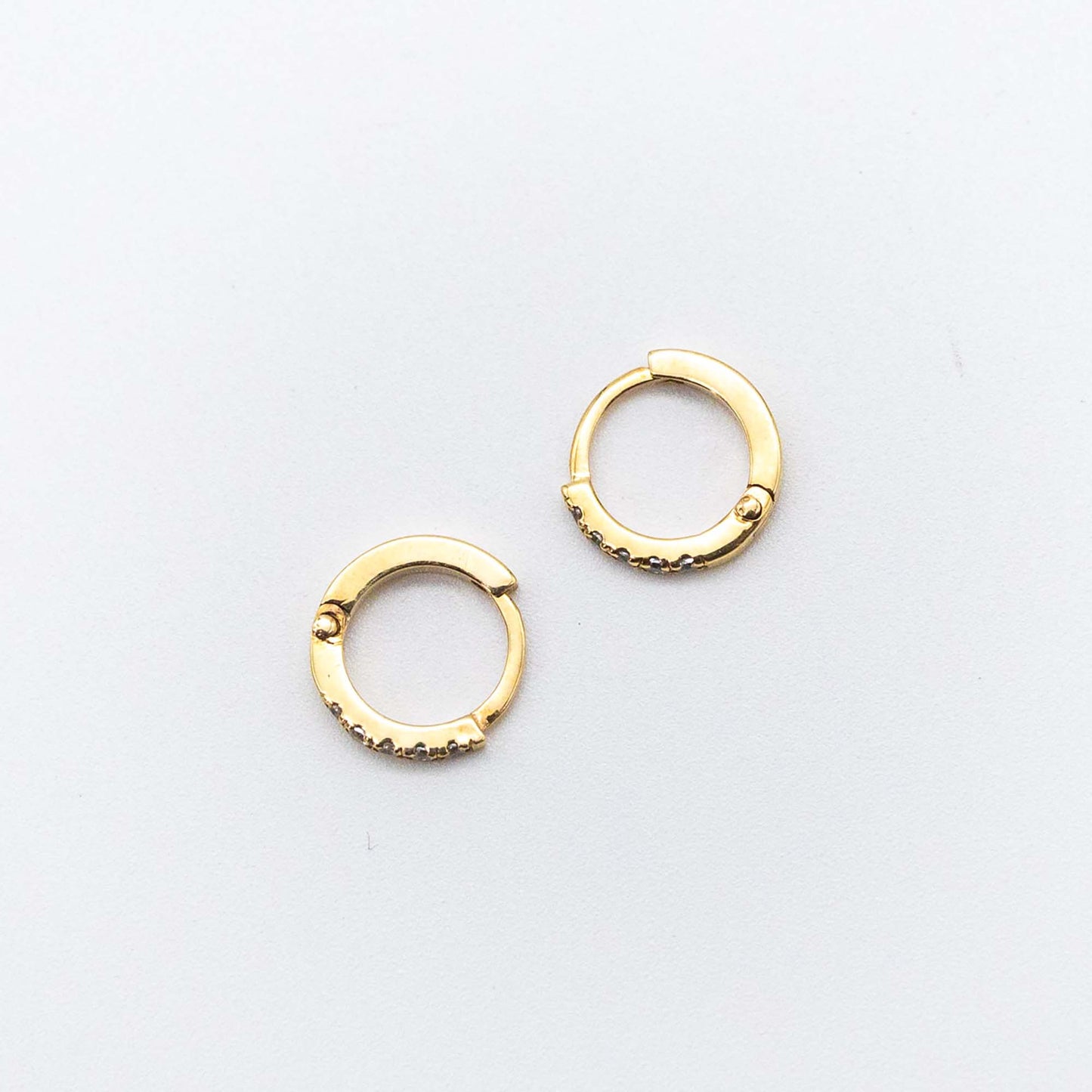 Pair of Mini Diamond Huggies 10mm in 9ct gold displayed on a white background