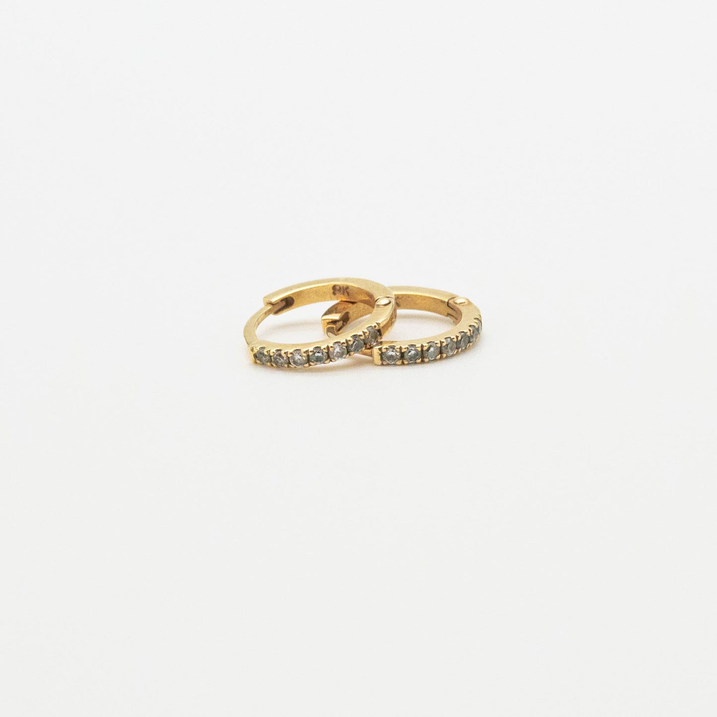 Mini Diamond Huggies 12mm displayed on a white background, showcasing seven round diamonds set in 9ct gold.