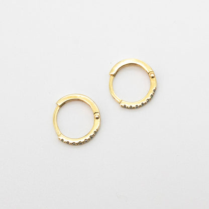 Mini Diamond Huggies 12mm displayed on a white background, showcasing seven round diamonds set in 9ct gold.