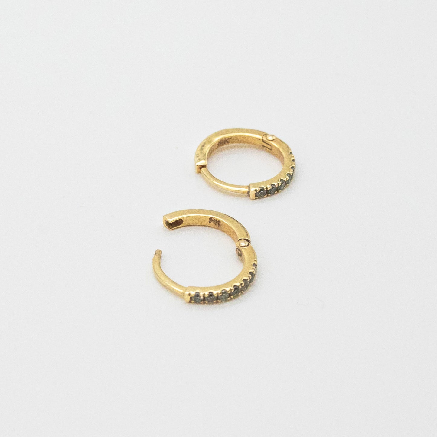 Mini Diamond Huggies 12mm displayed on a white background, showcasing seven round diamonds set in 9ct gold.