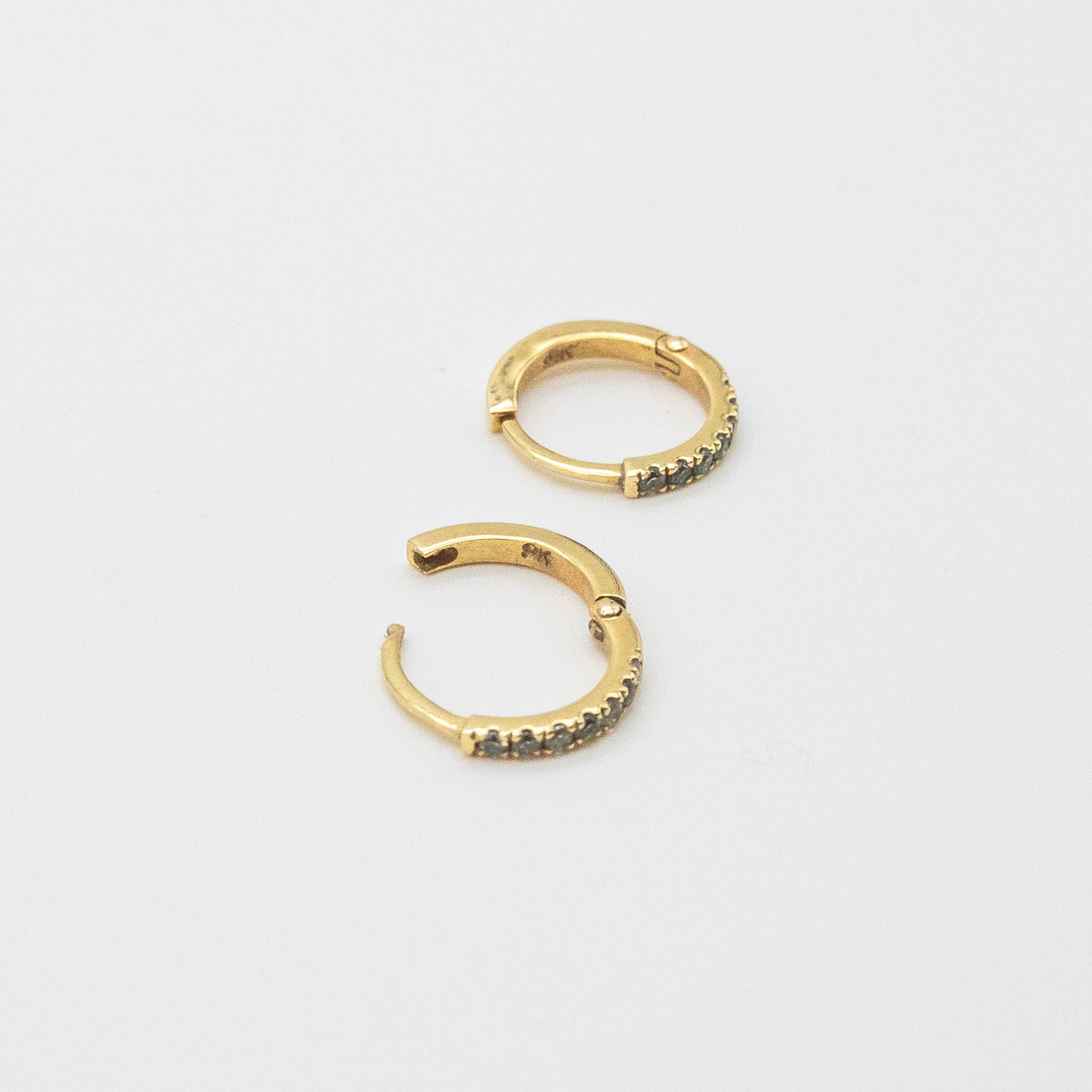 Mini Diamond Huggies 12mm displayed on a white background, showcasing seven round diamonds set in 9ct gold.