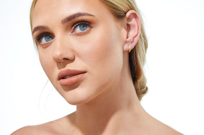 Mini Diamond Huggies 12mm displayed on a white background, showcasing seven round diamonds set in 9ct gold.