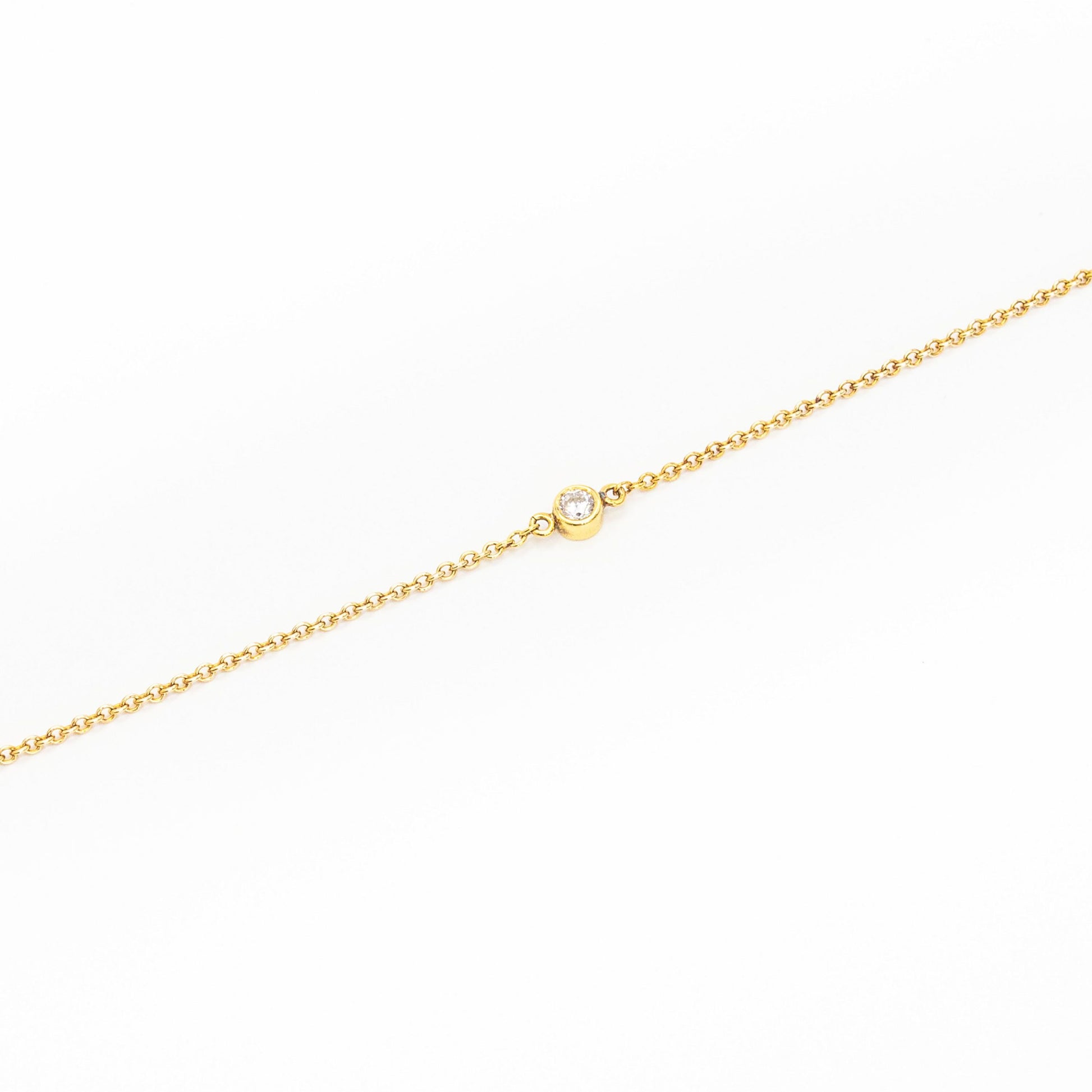 Minimalist gold bracelet featuring a single solitaire diamond, handcrafted by Leesha Fine Jewellery