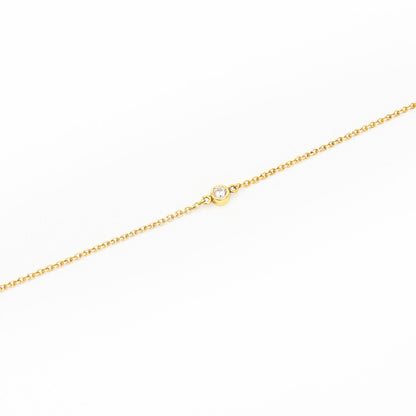 Minimalist gold bracelet featuring a single solitaire diamond, handcrafted by Leesha Fine Jewellery