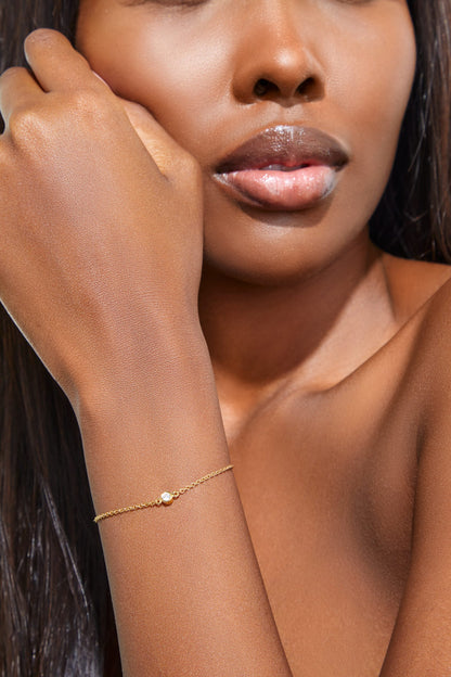 Minimalist gold bracelet featuring a single solitaire diamond, handcrafted by Leesha Fine Jewellery
