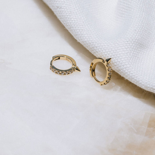 Pair of 9ct gold Spike Diamond Huggie earrings displayed on white background, showcasing front-facing diamonds.