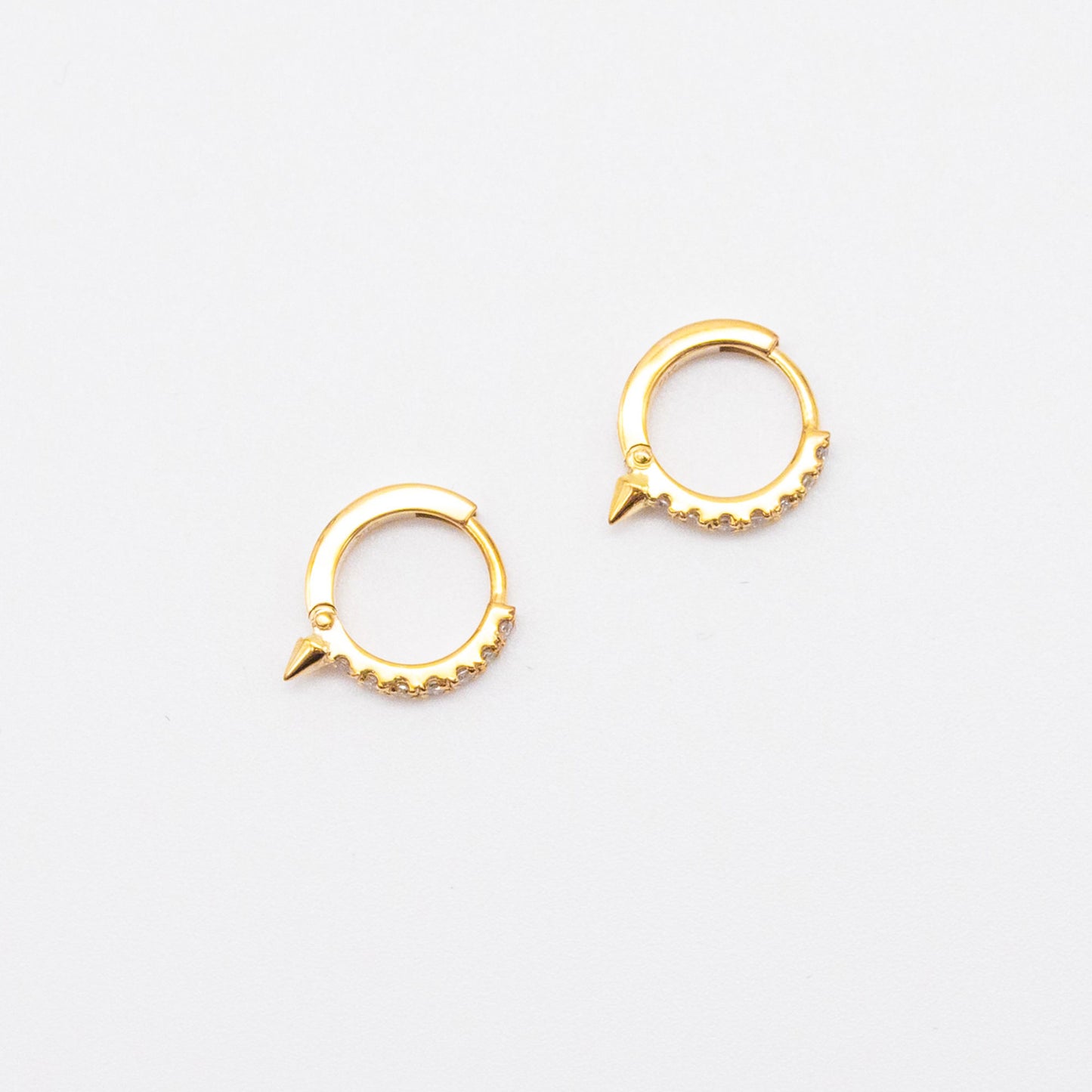 Pair of 9ct gold Spike Diamond Huggie earrings displayed on white background, showcasing front-facing diamonds.