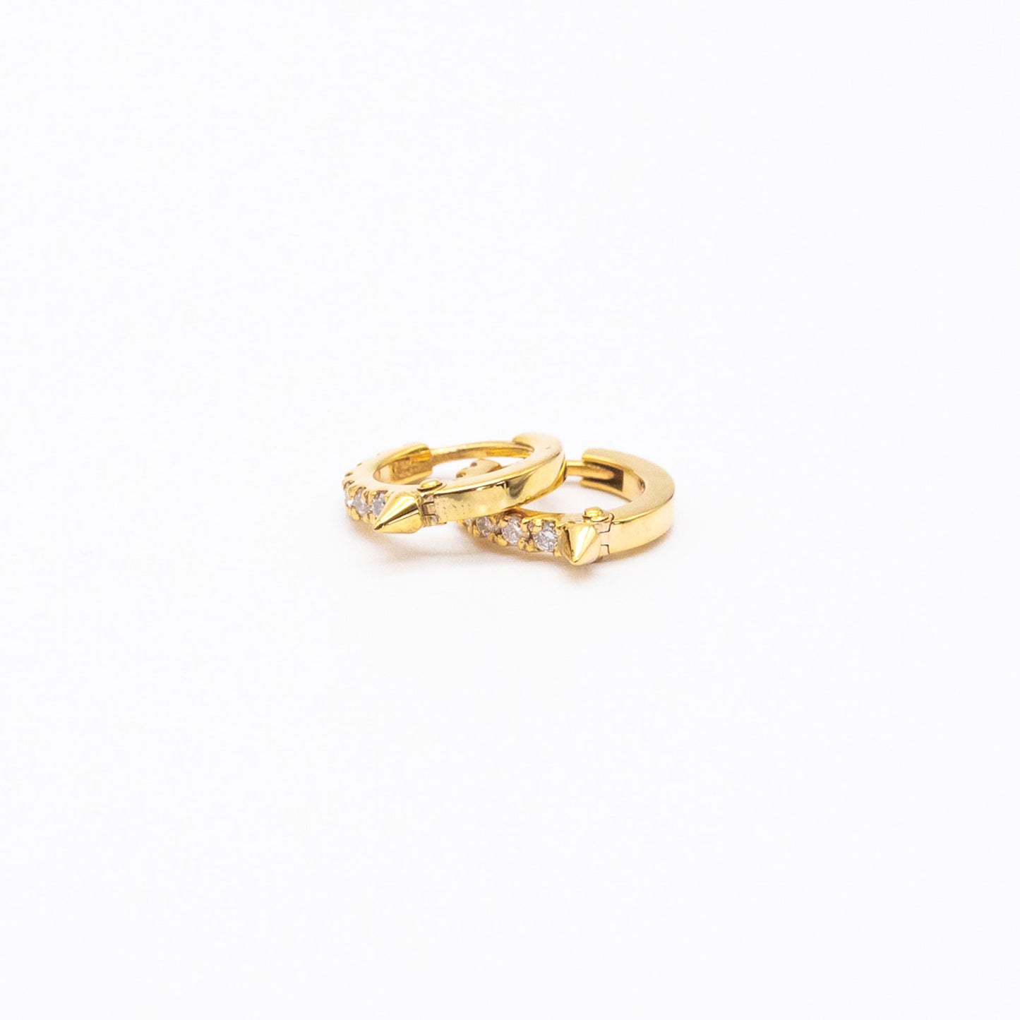 Pair of 9ct gold Spike Diamond Huggie earrings displayed on white background, showcasing front-facing diamonds.
