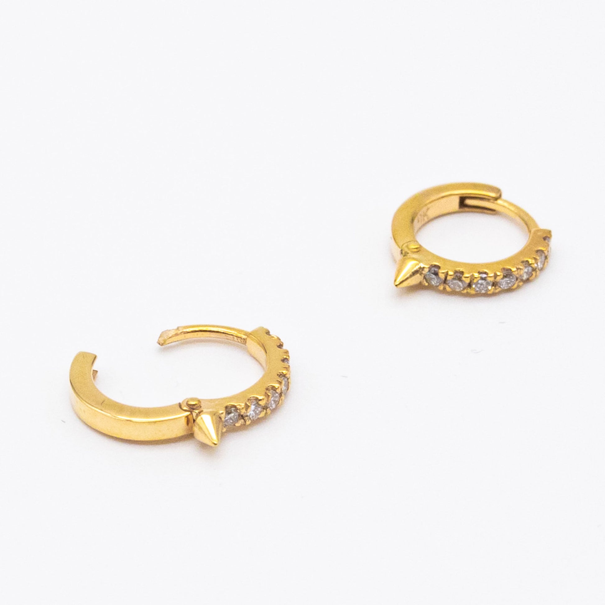 Pair of 9ct gold Spike Diamond Huggie earrings displayed on white background, showcasing front-facing diamonds.