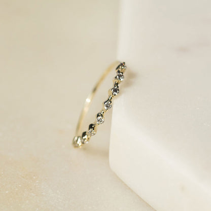 Spotted stacker ring with nine white diamonds on a thin 9ct gold band