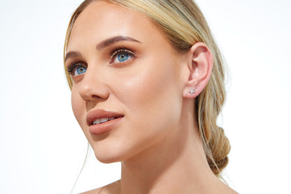 Close-up of 9ct gold star stud earrings with diamonds.