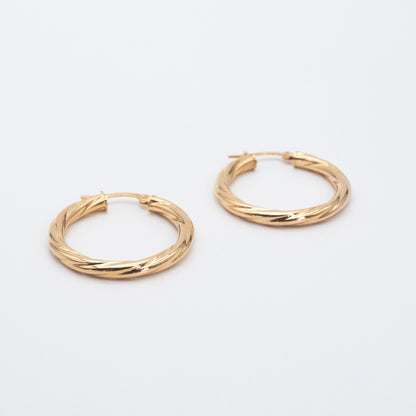 Textured 9ct gold hoop earrings featuring a 2mm twisted tube design.