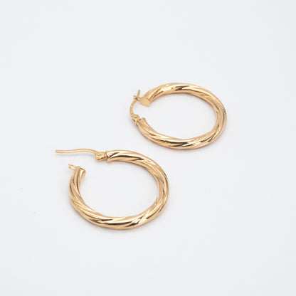 Textured 9ct gold hoop earrings featuring a 2mm twisted tube design.