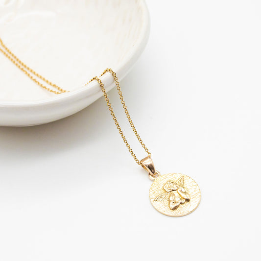 Guardian angel pendant necklace in 9ct yellow gold featuring a raised angel design and delicate adjustable chain.
