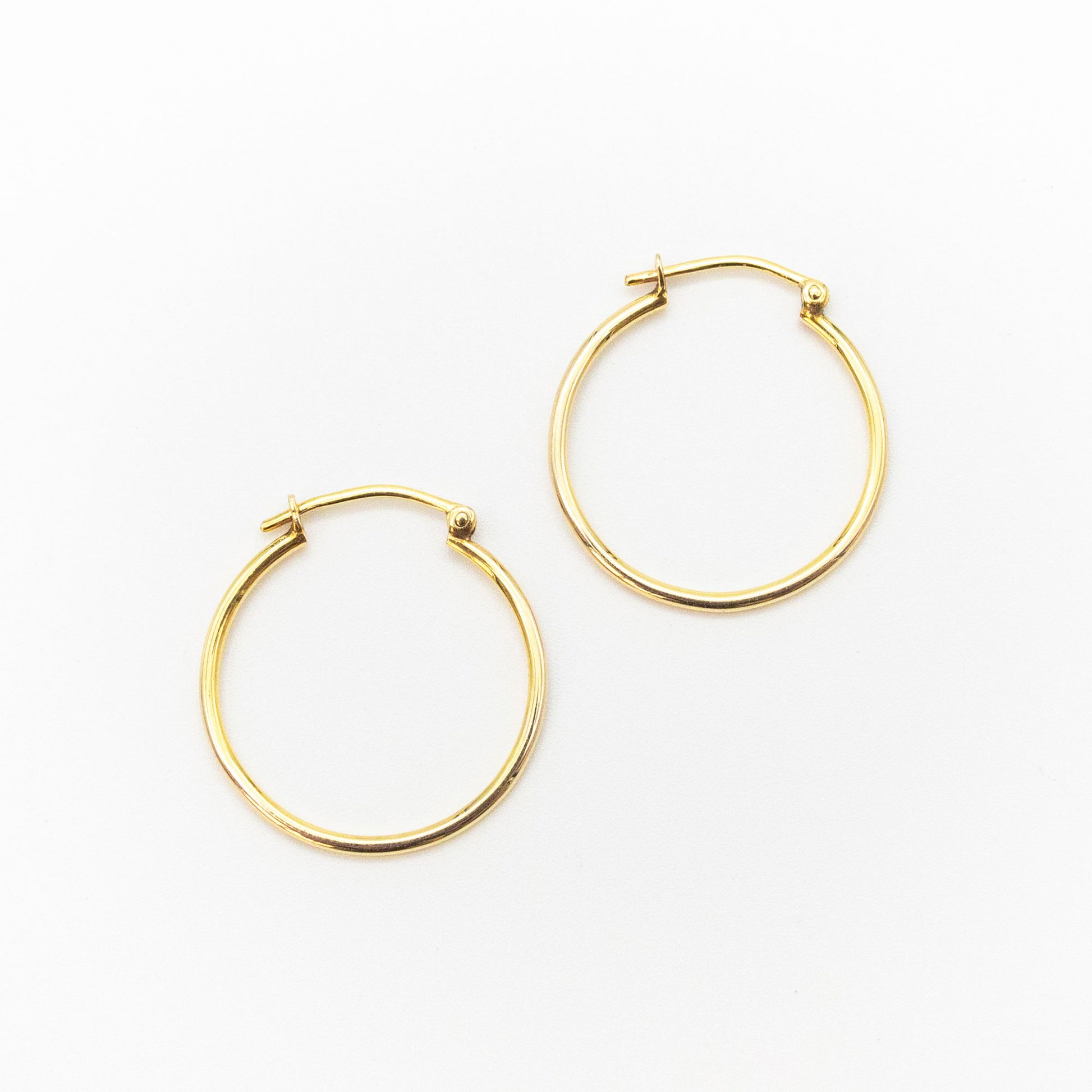Side-by-side view of medium 9ct gold hoop earrings