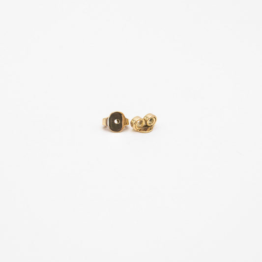 Back view of mini bold yellow gold stud earrings showing the posts and butterfly backs.